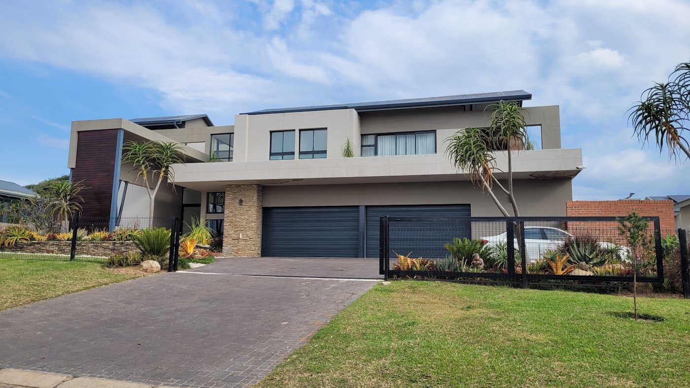 Modern home with dark garage doors